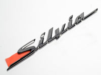 Genuine OEM Nissan S15 Rear "Silvia" badge - 84895-85F00 (Black Chrome)